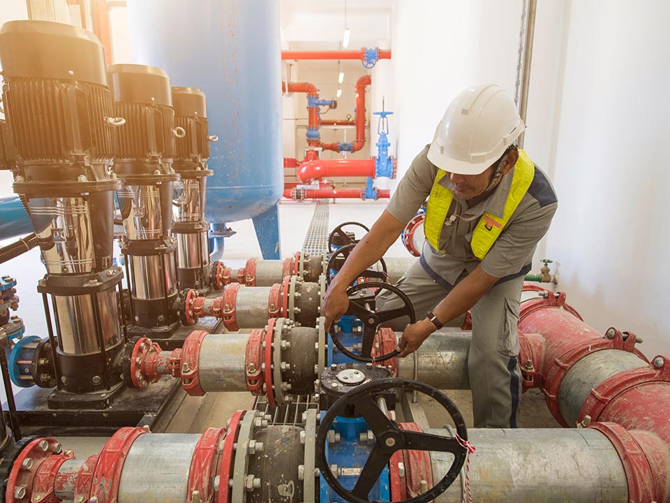 Technician operation fire control system valve high pressure water pump for the industrial fire pump system at water tank station in factory